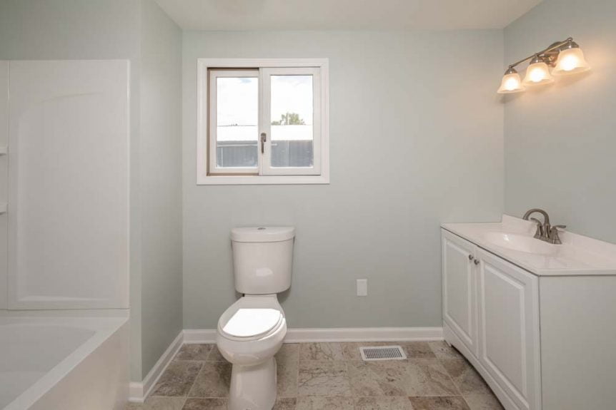 Newly Remodeled Bathroom with fresh cabinetry, paint and flooring