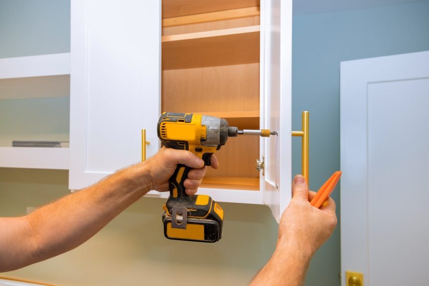 Home contractor installing cubboard door